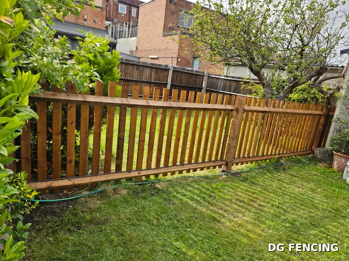 After: completed timber picket fence along the garden boundary