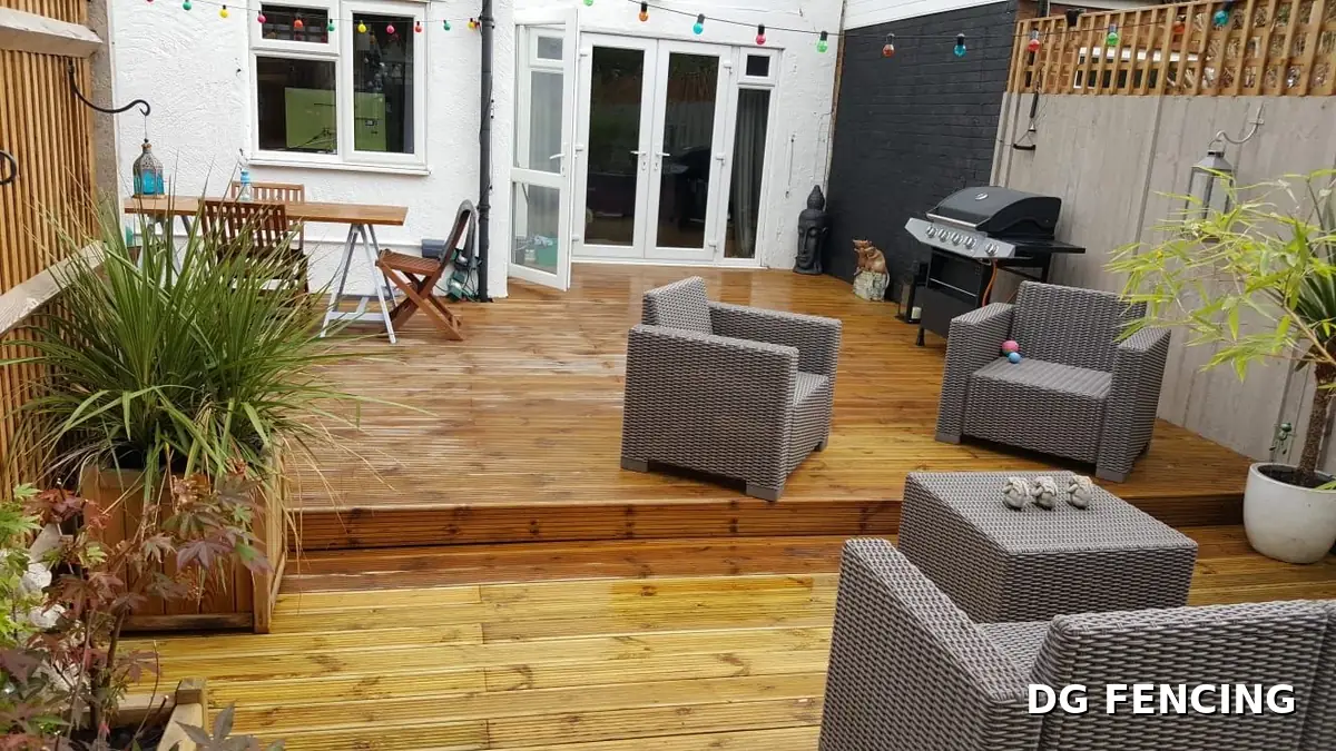 Split-level garden decking with seating area and festoon lights