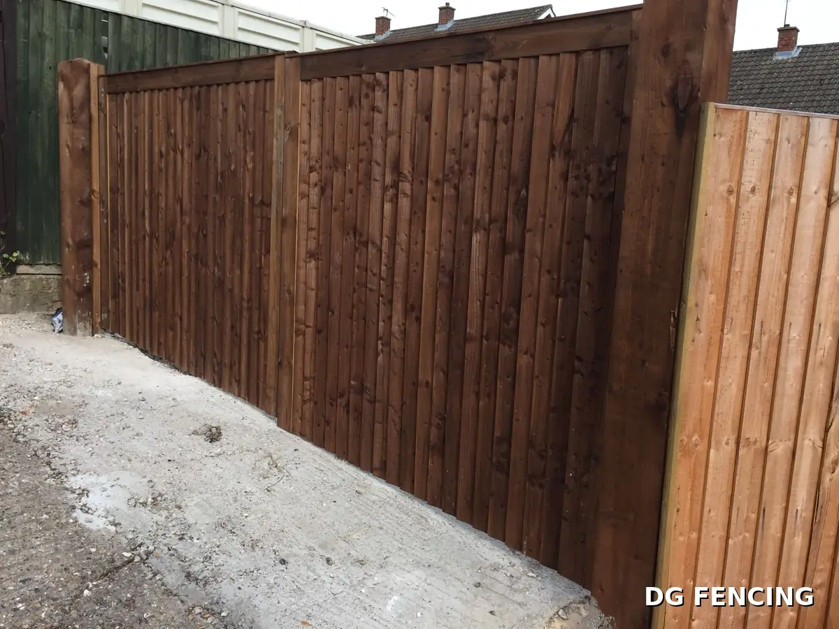 Bespoke dark timber gates between heavy duty posts