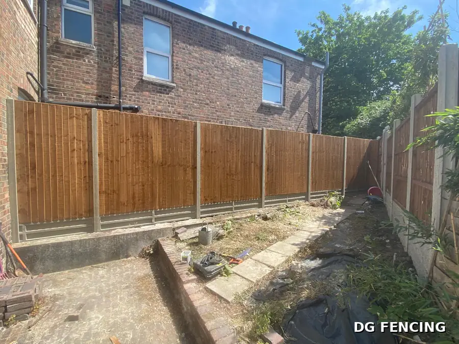 New closeboard featheredge fencing on concrete posts along a garden boundary
