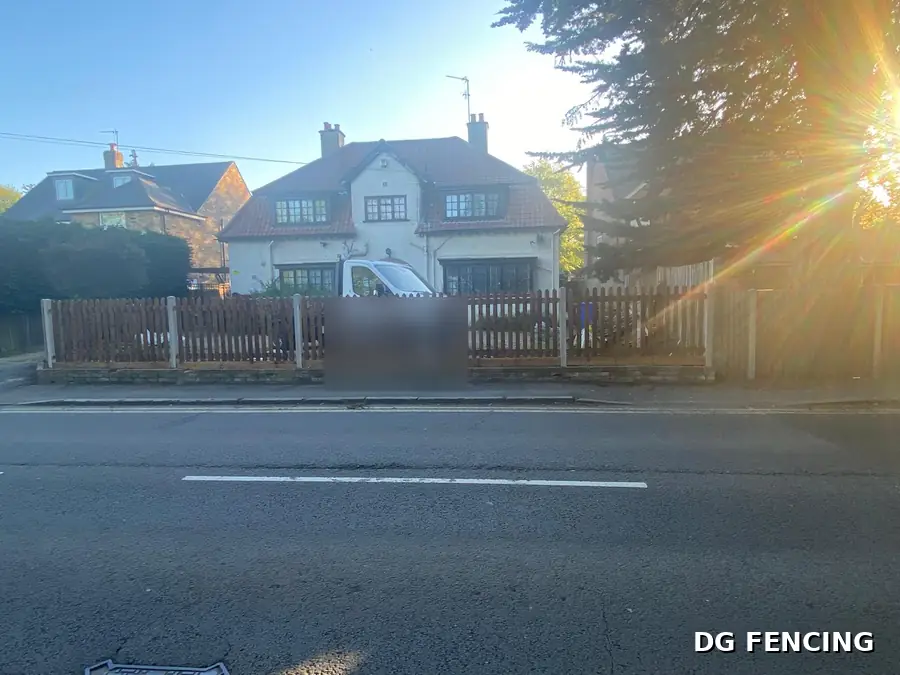 Traditional timber picket fencing along the front of a London house
